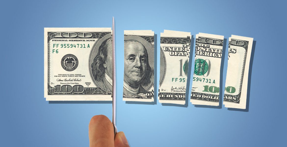 Front view of one hundred dollar banknotes, slicing with a knife on hand, isolated on white background.