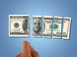 Front view of one hundred dollar banknotes, slicing with a knife on hand, isolated on white background.